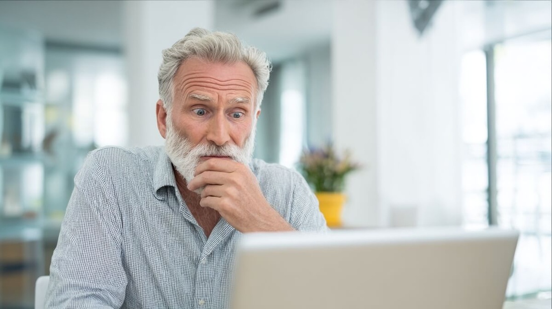 Un retraité inquiet face à un email suspect sur son ordinateur © SeniorActu Un retraité inquiet face à un email suspect sur son ordinateur © SeniorActu