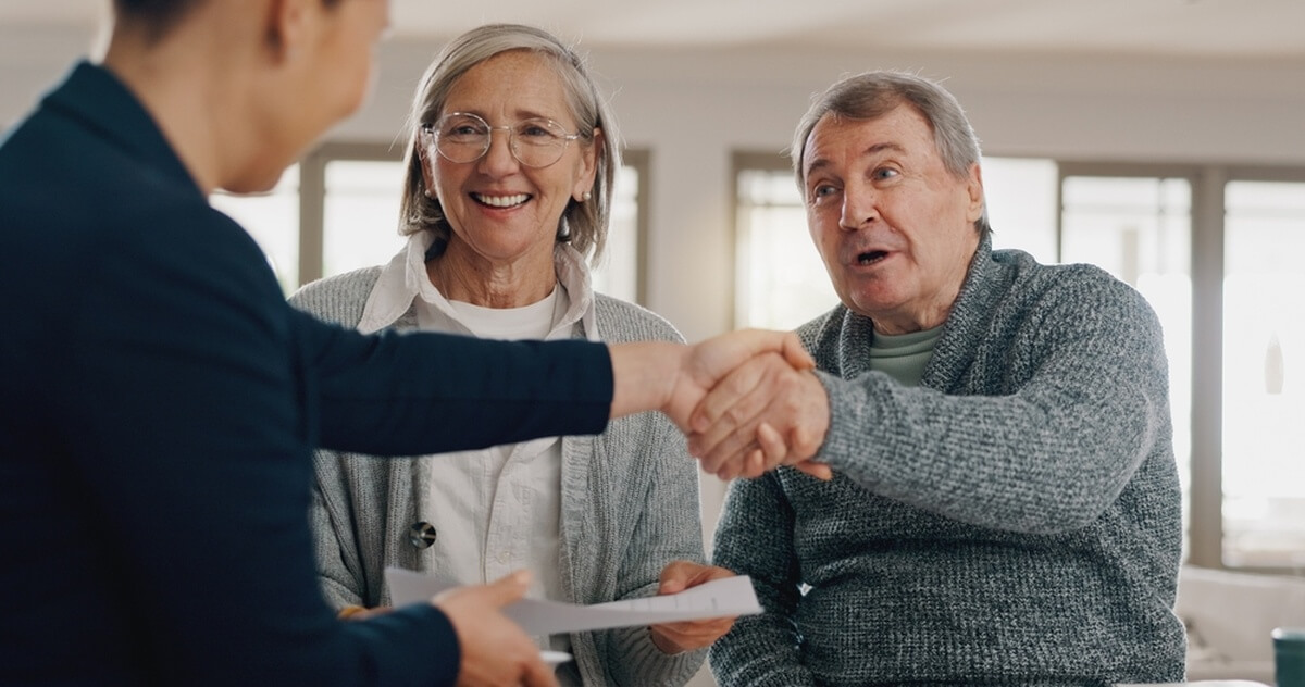 Couple de retraités avec leur conseiller en assurances © PeopleImages/shutterstock